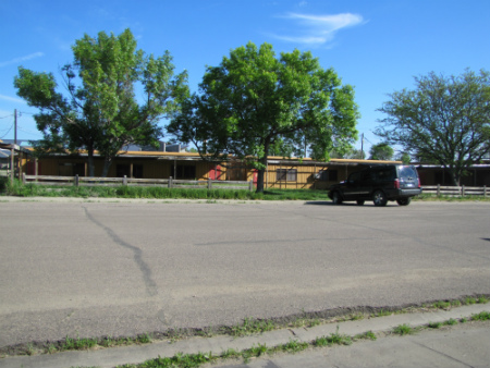 Outside view of old yellow school buildings